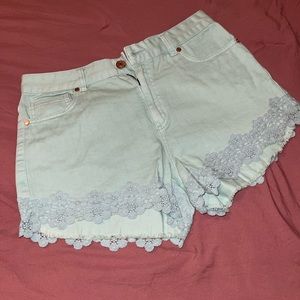 Light green casual shorts with floral lace design.